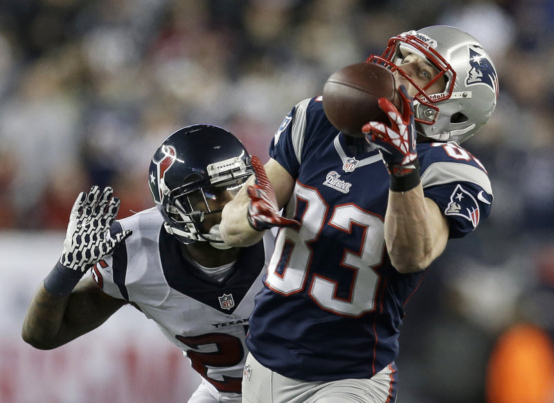 Wes Welker hauls in a pass behind Texans cornerback Kareem Jackson for a 47-yard gain in the first half Sunday at Gillette Stadium. The catch set up an 8-yard touchdown pass to Shane Vereen, and the Patriots went on to a 41-28 victory.