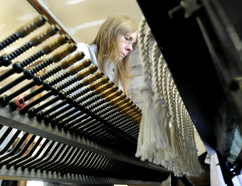 Corinne Hodsdon ties fringing on throws at the Brahms Mount factory.