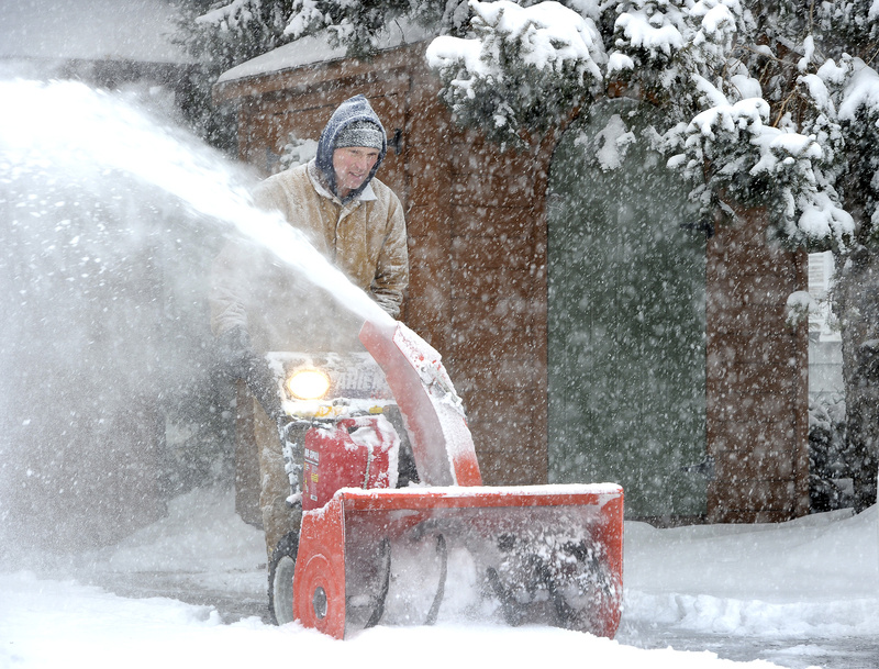 Rick Urban clears a neighbor's driveway along Capisic Street in Portland on Friday, as a massive snowstorm hit southern Maine. Residents helped each other through the blizzard, and public employees' planning and hard work eased the storm's impact.