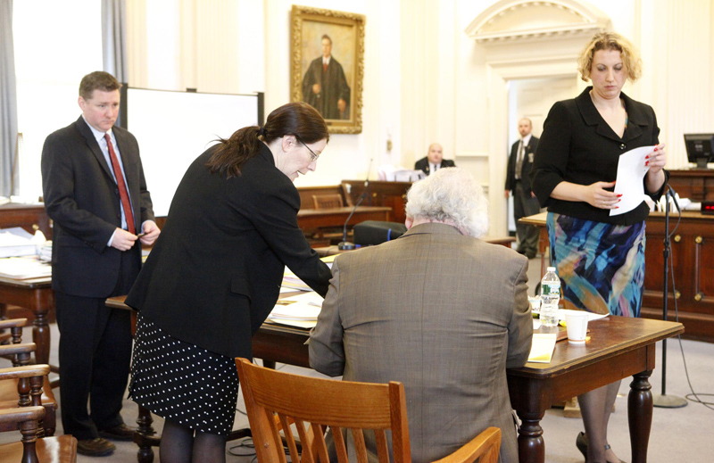 Deputy District Attorney Justina McGettigan, center, and Daniel Lilley, defense attorney for Mark Strong Sr., talk during a hearing recess. At left is Assistant District Attorney Patrick Gordon and at right is Tina Nadeau, co-counsel for Strong. Nadeau and Lilley argued on Tuesday for charges against Mark Strong Sr. to be dropped. They said prosecutors had failed to release key evidence before the trial that could have been used in Strong's defense.