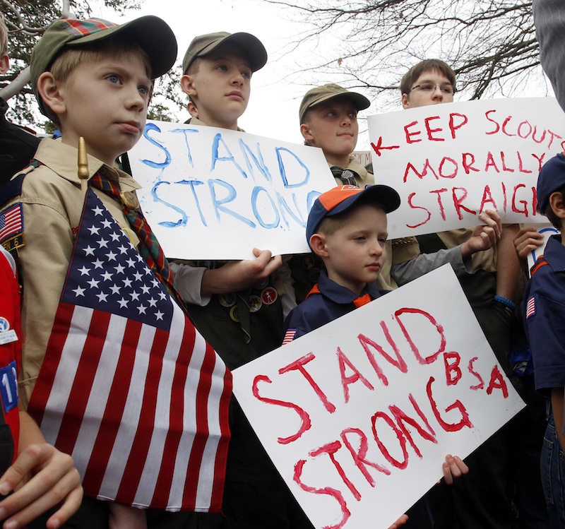 Clockwise from left, Boy Scouts Eric Kusterer, Jacob Sorah, James Sorah, Micah Brownlee and Cub Scout John Sorah hold signs at the “Save Our Scouts” Prayer Vigil and Rally in front of the Boy Scouts of America National Headquarters in Irving, Texas, Wednesday, February 6, 2013. The Boy Scouts of America said Wednesday it needed more time before deciding whether to move away from its divisive policy of excluding gays as scouts or adult leaders. (AP Photo/Richard Rodriguez)