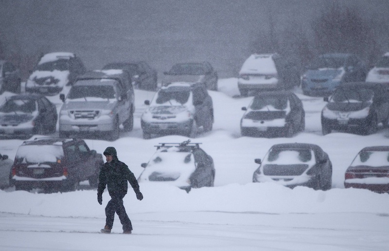 A man battles fierce winds as he climbs a hill after leaving his car in a parking lot to avoid being towed during a parking ban, Friday, Feb. 8, 2013, in Portland, Maine. The National Weather Service issued a blizzard warning for Maine's southern coast. The forecast calls for up to 2 feet of snow and winds gusting to 50 mph. (AP Photo/Robert F. Bukaty)