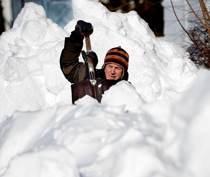 John Morrill Read of Saco shovels his way through the deep snow in an effort to get his vehicle out of his garage on School Street in Saco on Sunday.