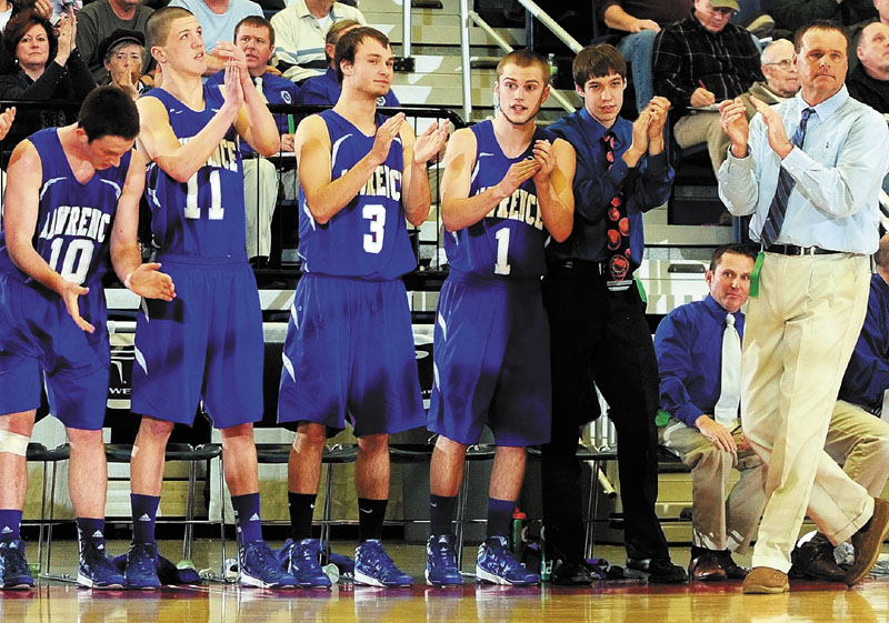 Lawrence coach Mike McGee, right, and the bench cheer on the Bulldogs late in fourth quarter of a 49-41 win over Edward Little in an Eastern Class A semifinal at the Augusta Civic Center.