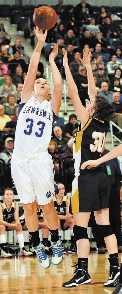 Staff photo by Joe Phelan Lawrence's Nia Irving shoots over Mt. Blue's Miranda Nicely during an Eastern Class A tournament game on Friday February 15, 2013 at the Augusta Civic Center.