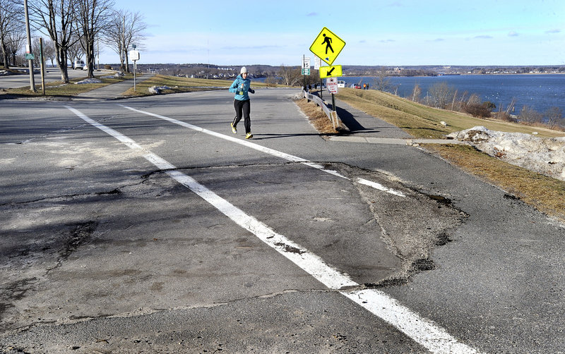 A jogger runs across the top of Cutter Street in Portland on Friday, Feb. 1, 2013. The city is planning to reduce the crosswalk in length from 100 feet to 30 feet.