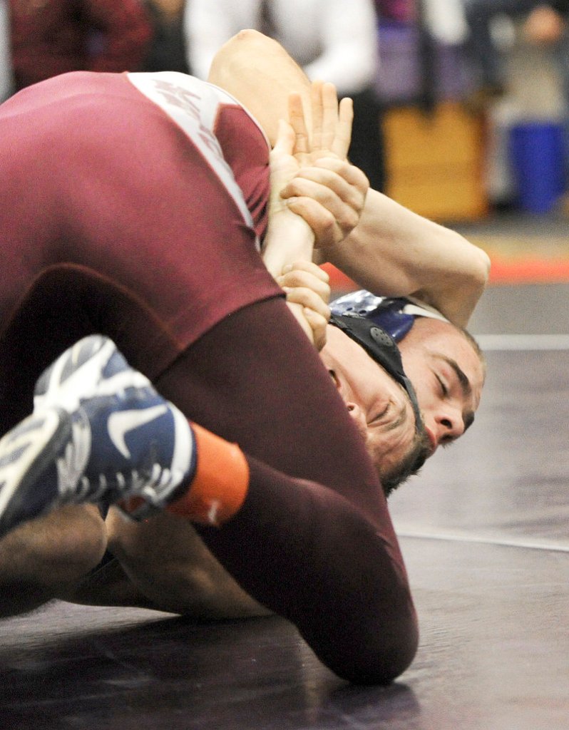 Jesse McNally, top, of Noble and Matt Doe of Kennebunk compete in the 138-pound consolation final. McNally won by pin at 1:44.