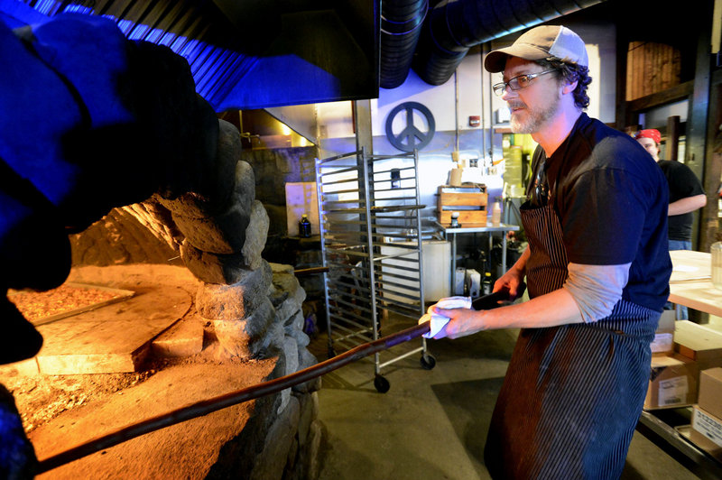 Chef Rob Evans, owner of Duckfat, cooks for a benefit at Flatbread in Portland on Sunday. Evans will compete for $50,000 on “Chopped Champions” Tuesday night.