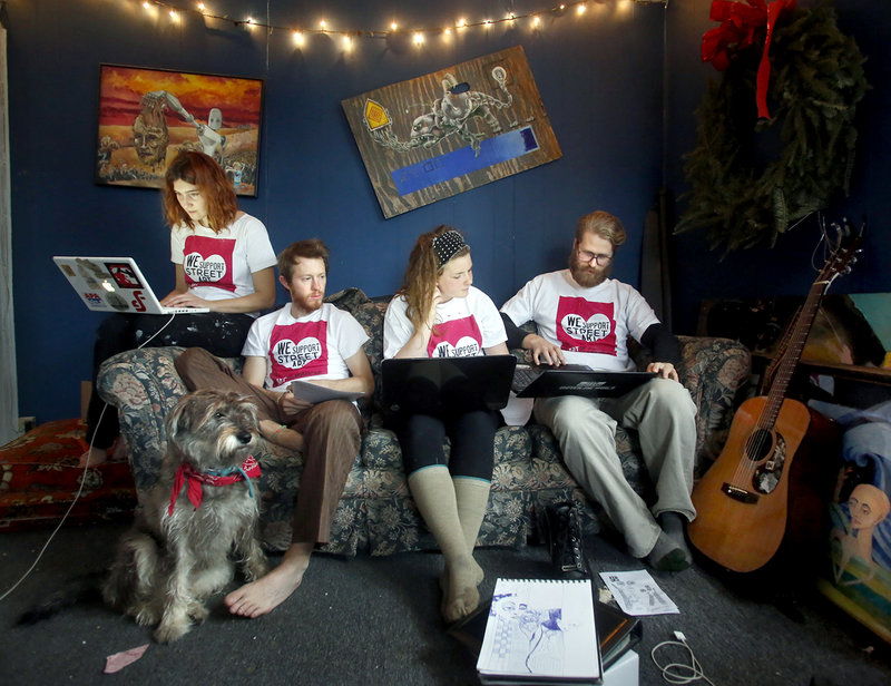 Members of the Creative Community Coalition, from left, Abbeth Russell, William Hessian, Marrion Ladd and Asher Platts work on their presentation Monday at Russell’s and Hessian’s home in Portland. The city said Tuesday it is pressing forward with a plan to create a registration system for street art vendors, likely setting up a legal showdown with free-speech advocates.