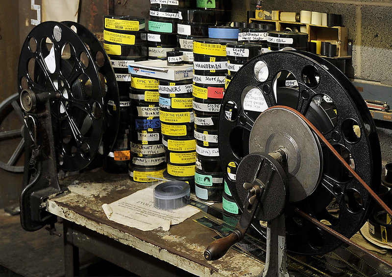 Here, dozens of short films and cartoons, that are usually shown before the main feature, sit on a work bench next to the theater's old-fashioned film reels.