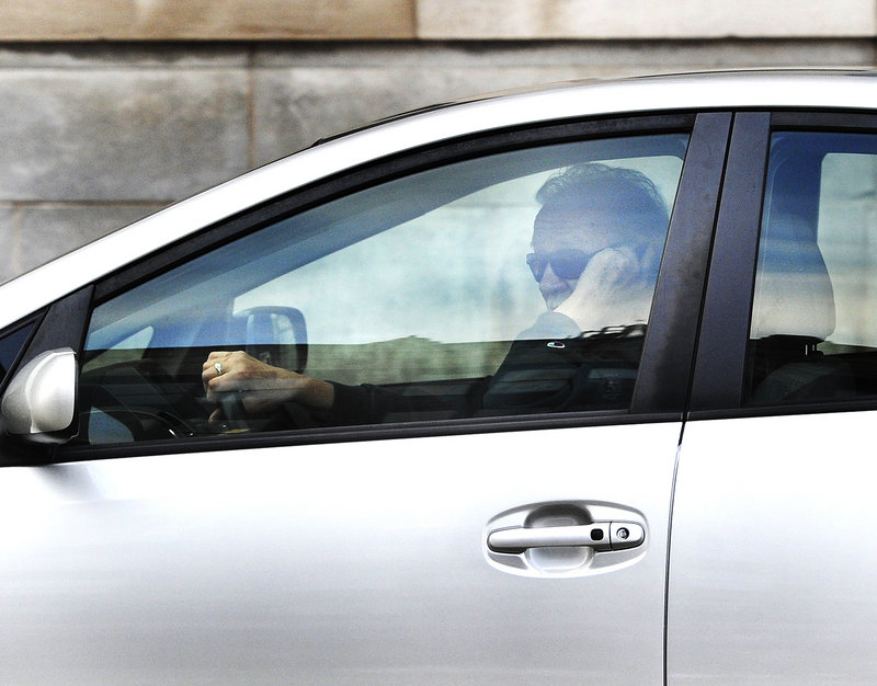 A driver talks on his cellphone while driving on Portland's Congress Street on Wednesday, Feb. 13, 2012.