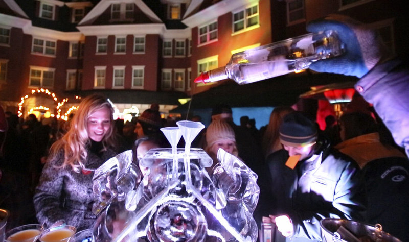 Vodka is poured into a funnel in an ice block during the Ice Bar at the Portland Harbor Hotel in Portland on Saturday, January 26, 2013. Ice bars have become hip, high-profile events across Maine.