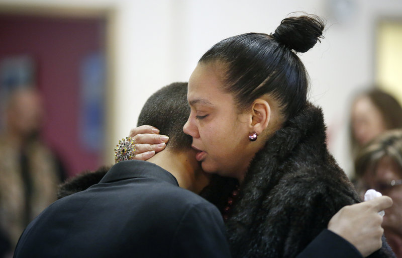 Mikey Epperson, 16, of New London, Conn., at left, is comforted by Sondra Wilson of Virginia, at right, before the start of a memorial service for Epperson's grandmother and Wilson's mother, Dale Fussell, 64, at the United Church of Christ on Congress Avenue in Bath Tuesday, February 19, 2013. Fussell was killed Tuesday, Feb. 12, in a propane explosion at her Bluff Road duplex.