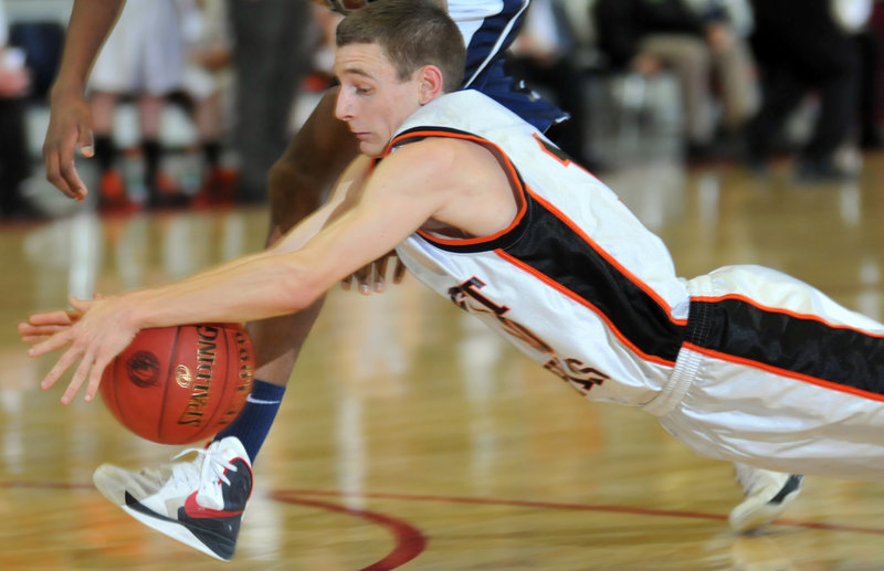 Brandon Ouellette of Forest Hills dives to beat an A.R. Gould player to a loose basketball Wednesday during their Western Class D semifinal. Ouellette scored 19 points in a 78-50 victory.