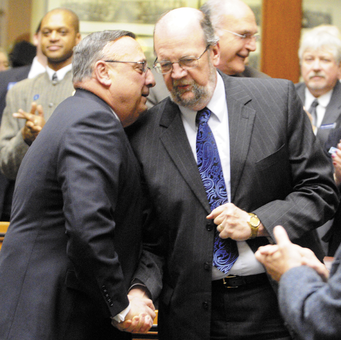 Staff photo by Joe Phelan Gov. Paul LePage, left, chats with Rep. Robert Nutting, R-Oakland, as he enters the House chamber to give his State of the State address on Tuesday February 5, 2013 in the State House in Augusta.