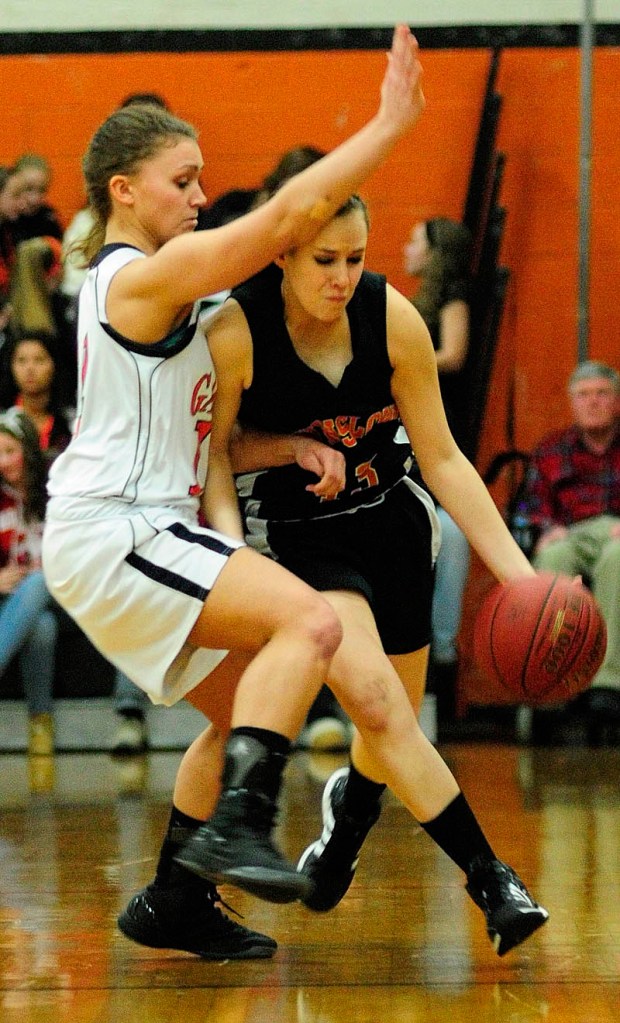 TIGHT DEFENSE: Gardiner’s Taylor Banister, left, tries to stop a drive by Winslow’s Alyssa Wood during an Eastern Class B preliminary game Tuesday in John A. Bragoli Memorial Gym at Gardiner Area High School.