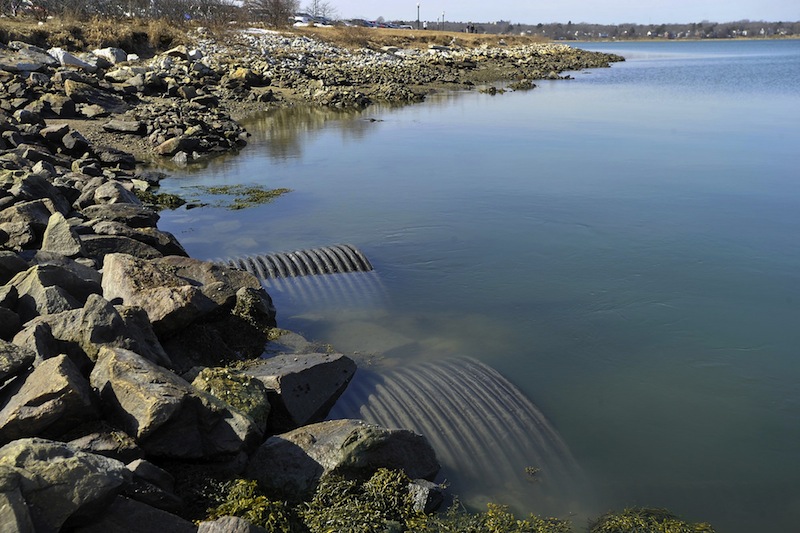 In this March 2012 file photo, a pipe near Preble Street Extension and Marginal Way that discharges a combination of untreated sewage and storm water run-off into the Back Cove after heavy rainfall. The city has agreed to pay more than $53,000 in fines for sewer overflows that contaminated waterways, the Environmental Protection Agency announced Wednesday.