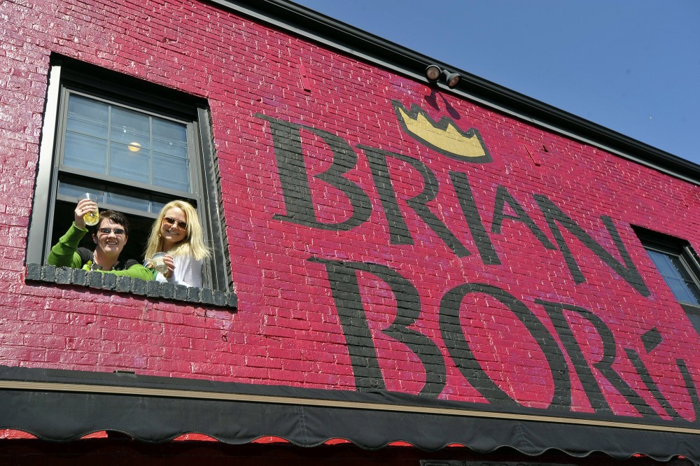 In this Saturday, March 17, 2012 file photo, Carrie Mahoney and her neighbor, Lisa Henderson, enjoy the view of the Sy. Patrick's Day Parade from the second story window of Brian Boru in Portland. A bill that would allow bars to open three hours earlier this St. Patrick's Day failed to advance on Tuesday, March 12, 2013.