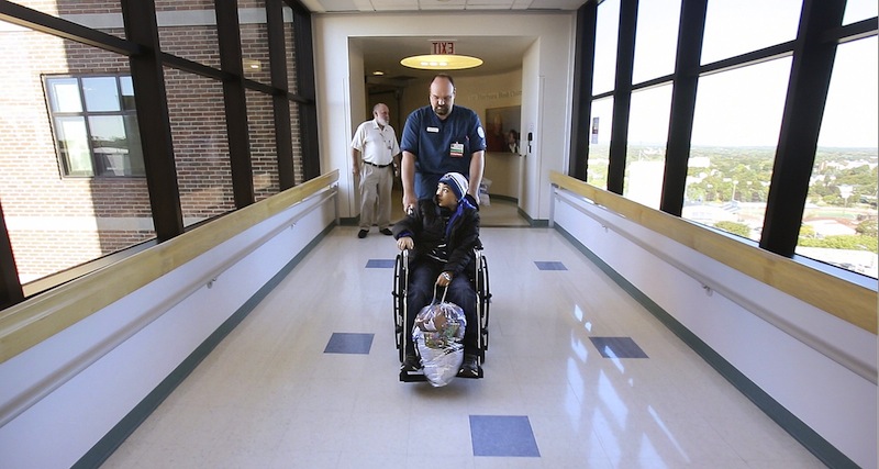 Patient Jose Marroquin Galan leaves Maine Medical Center on Sept. 27, 2012, five days after having heart surgery. Hospital investments around the state are on hold as Maine's 39 hospitals wait for $484 million in overdue Medicaid reimbursements.