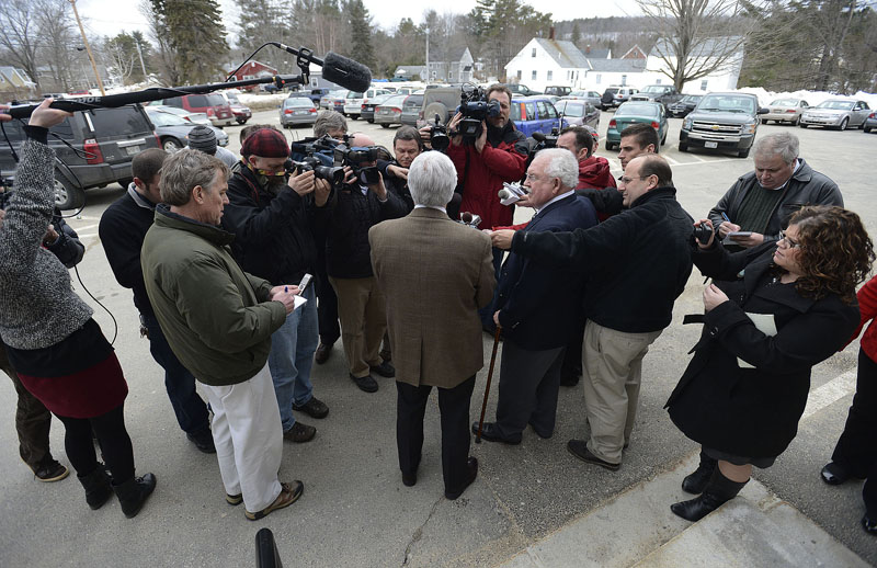 Mark Strong Sr. center, faces the media after he was found guilty of 12 counts of promotion of prostitution and one count of conspiring to promote prostitution Wednesday, March 6, 2013. To his right is his attorney Dan Lilley.