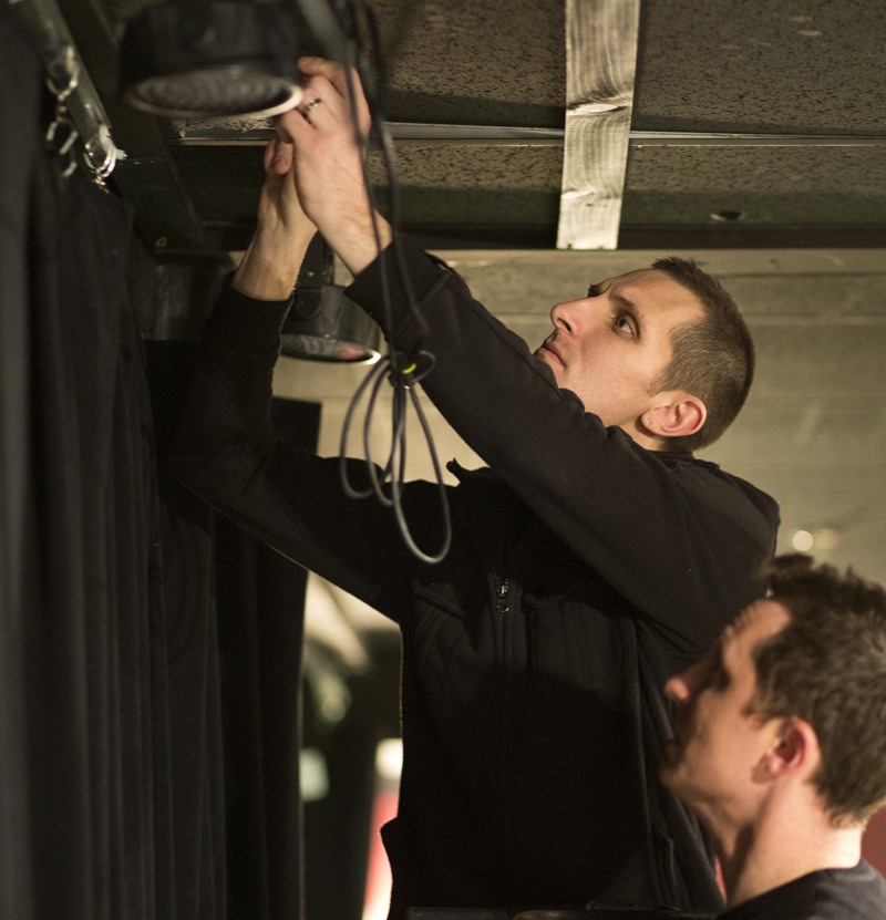 Matt Tardy runs wiring along the ceiling behind the stage at the Theater of Awesome on Depot Street in Freeport Thursday, March 7, 2013. Matt and his brother, Jason will kick off their new physical comedy routine called "AudioBody" Friday night, March 8.