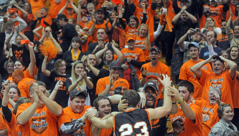 Evan Worster celebrates with fans after Forest Hills defeated Central Aroostook 55-48 in the Class D boys' basketball state championship game Saturday at the Bangor Auditorium.