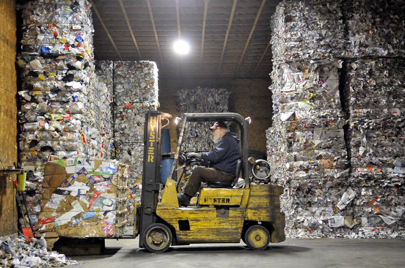 Ron Slatermanager of the Sandy River Recycling Association loads a 1-ton pallet of cardboard onto the scale in the storage area in Farmington on Thursday.