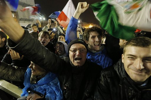 Crowds cheer after white smoke billowed from the chimney on the Sistine Chapel indicating that a new pope has been elected in St. Peter's Square at the Vatican, Wednesday, March 13, 2013. (AP Photo/Dmitry Lovetsky)