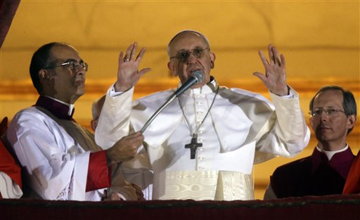 Pope Francis waves to the crowd from the central balcony of St. Peter's Basilica at the Vatican on Wednesday.