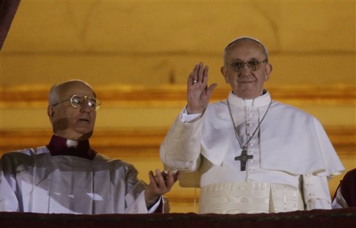 Pope Francis waves to the crowd from the central balcony of St. Peter's Basilica at the Vatican on Wednesday. Bergoglio, who chose the name of Francis, is the 266th pontiff of the Roman Catholic Church.