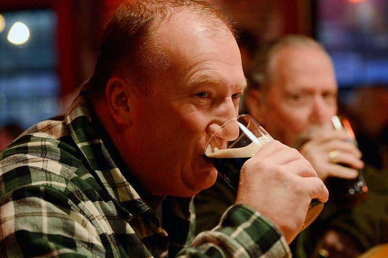 Hal Cozens of Orlando, Fla., takes a sip of his pint during St. Patrick's Day celebrations at Brian Boru on Sunday. Cozens says he came back to his hometown of Portland to celebrate St. Patrick's Day.