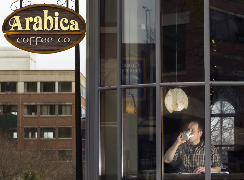 Kevin Sturtevant, an English instructor at SMCC, sips from a coffee mug at Arabica Coffee on Friday. Sturtevant says he is opposed to Styrofoam cups because of the waste they cause.