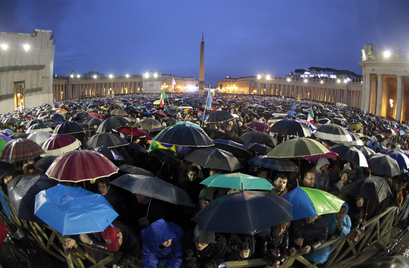 Faithful wait for smoke to rise from a chimney on top of the Sistine Chapel during the second day of voting for the election of a new pope at the Vatican.