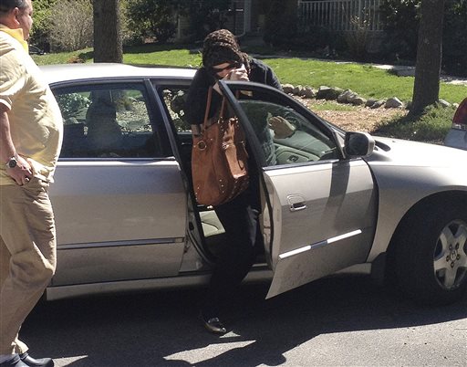 Katherine Russell Tsarnaev, wife of Boston Marathon bombing suspect Tamerlan Tsarnaev, exits a car at the home of her parents in North Kingstown, R.I., on Sunday. At left is her father, Warren Russell.