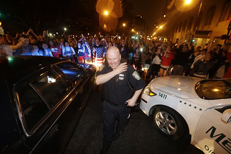 A police officer reacts to news of the arrest of one of the Boston Marathon bombing suspects on Friday in Boston. Dzhokhar Tsarnaev was captured in Watertown, Mass., after a manhunt that left the city virtually paralyzed.