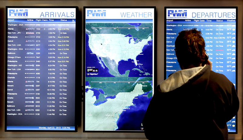 A man checks to see if a flight is on time at the Portland International Jetport on Monday. Congress has passed a bill to end sequester-driven staffing shortages that caused delays and cancellations in Portland and across the country. But lawmakers haven't said anything about easing funding cuts that affect hungry children and elderly shut-ins.