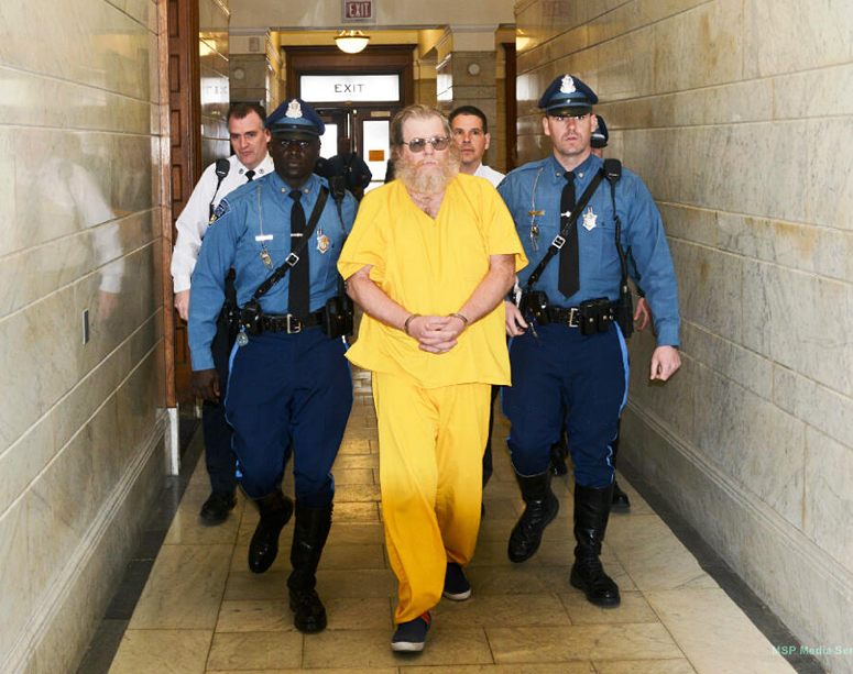 Massachusetts State Troopers lead convicted rapist Gary Irving into the Norfolk District Courthouse in Dedham on Monday for his first court appearance in Massachusetts since his capture last week in Gorham, Maine.