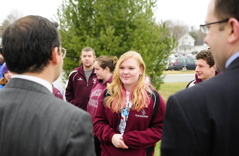 Student protest leader Lauren Umberhind, a senior at Richmond High School, center, chats with the two Democratic legislators that represent her town, Rep. Seth Berry, left, and Sen. Seth Goodall, before marching around the State House on Friday. Goodall mentioned that he also attended Richmond High School.