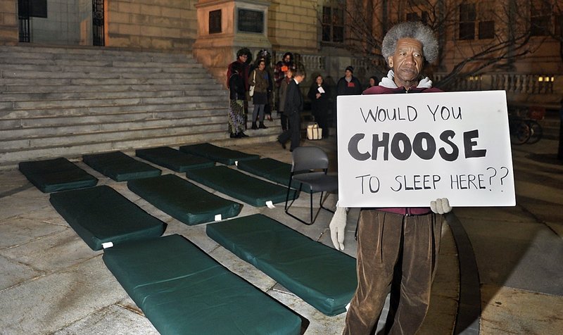 Nick Nicholson with Homeless Voices for Justice stands near pads that homeless people sleep on in shelters during a vigil last November at Portland City Hall. The city’s Oxford Street shelter is full every night and has been for a year, driving some to sleep outside – like Brian Barbour, 53, who died Saturday in a tent fire in the woods off West Commercial Street.