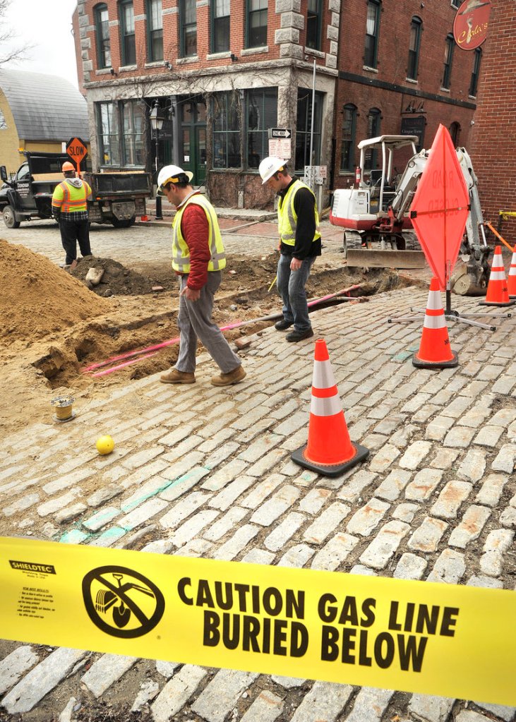 Unitil project manager Matt Doughty and project leader Joe Renda look over an excavation site in the Old Port. Unitil and its subcontractors plan to stop working on line installation by Memorial Day, the unofficial start of the tourist season.