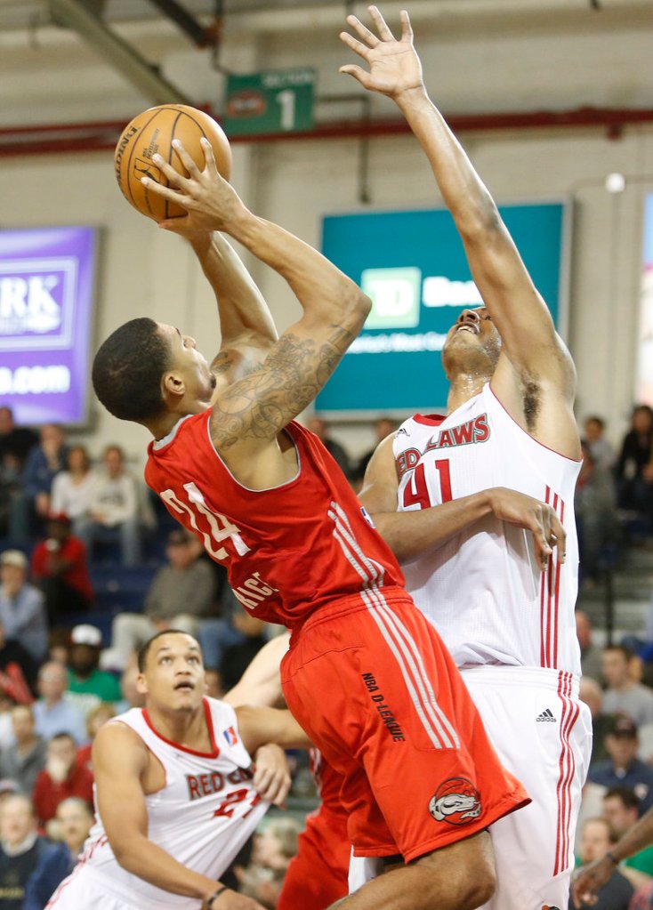 Glen Rice Jr. of the Rio Grande Valley Vipers finds a way to get a shot over Fab Melo of the Maine Red Claws in the third quarter of their D-League playoff game Thursday night at the Portland Expo. The Vipers held on, 120-118.