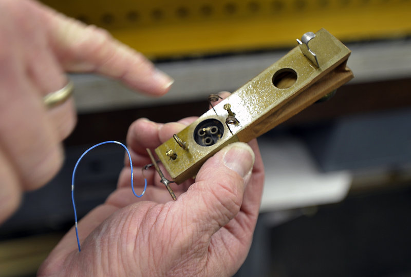 Jim Bennett of the Connecticut organ restoration company Foley-Baker Inc. explains the workings of an organ part.