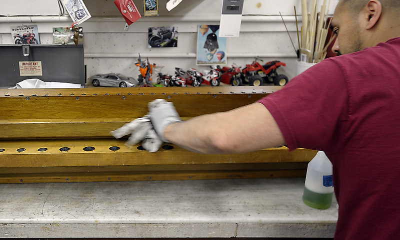 Mee Racz works to prepare the organ’s offset chest for refinishing, as part of the organ restoration project.