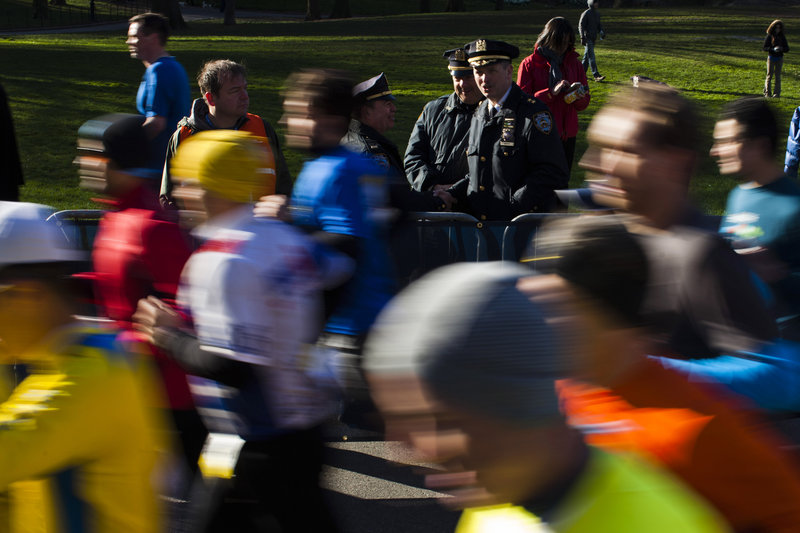 Police officers monitor a race organized by the New York Road Runners on Sunday at Central Park in New York City. Heightened security was in place in response to the Boston Marathon bombings. In Boston, the police commissioner said the arsenal of weapons and unexploded bombs possessed by the two suspects suggested they were planning other attacks.