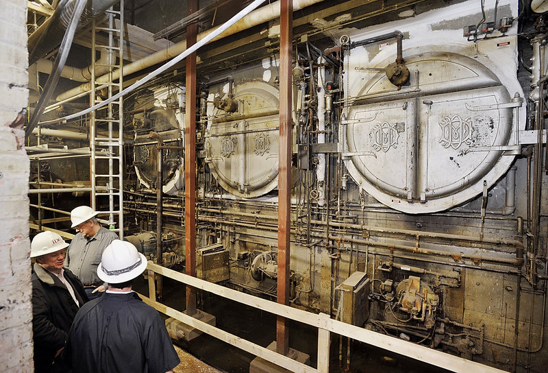 Here, project managers discuss what will become of the old coal fired heating system installed in the original Eastland Hotel. They are too large to be removed and may become a tourist attraction, they joked. A newer, "state of the art" HVAC system will be installed nearby.