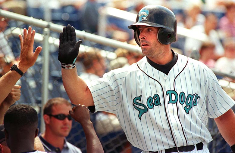 STAFF PHOTO BY JOHN EWING -- Wednesday, August 18, 1999 -- Chris Norton is greeted by teammates after hitting his 34th home run of the season to give the Sea Dogs a 4-2 lead in the seventh inning. John Ewing