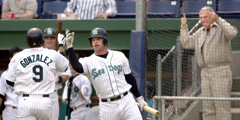 Staff Photo by Gordon Chibroski, Friday, May 24, 2002: Sea Dog #9, Adrian Gonzalez gets cudos from teammate, Matt Padget after hitting the teams first home run of the game. Team owner, Dan Burke, seems happy with the effort as well. Padget went on to hit another home run giving the Sea Dogs the lead for a short time. Action at Hadlock Field against the Reading Phillies. Baseball Gordon Chibroski