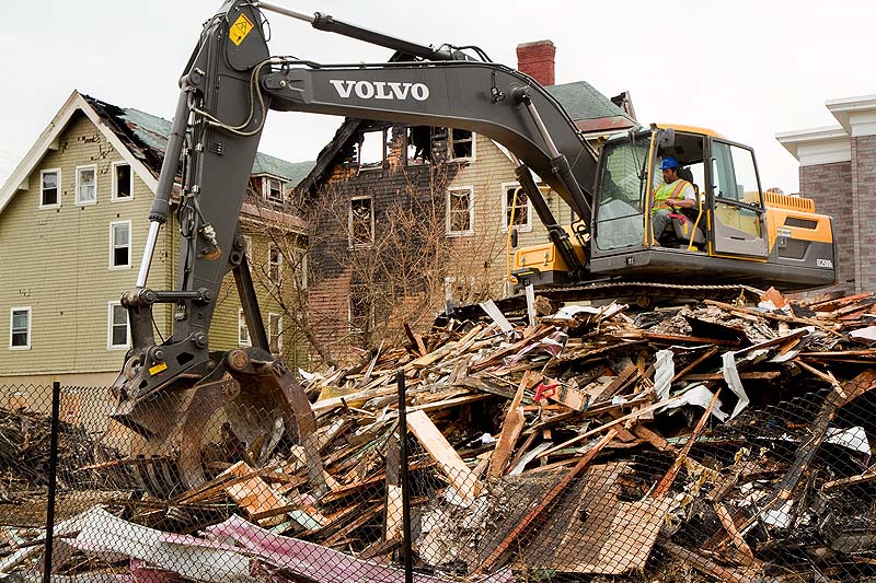 A demolition crew cleans up the rubble from the Blake Street fire in Lewiston on Thursday. Lewiston police have charged a 12-year-old boy with setting the fire.