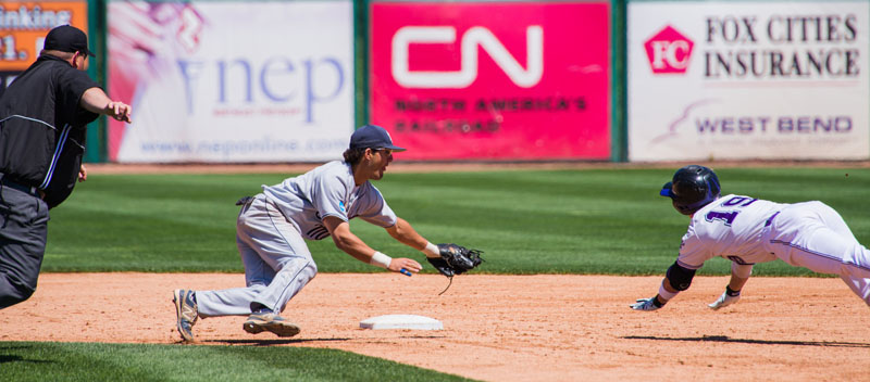 Anthony Pisani of USM dives to make a tag on Blake Littlejohn of Millsaps, who was attempting to stretch a single into a double. Littlejohn overslid the bag and was tagged out. Division Three Baseball Tournament University of Southern Maine