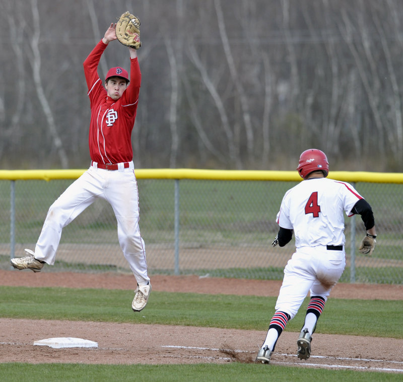 South Portland first baseman Dillon Burns pulls down a high throw in time to tag Brendan Hall of Scarborough during unbeaten Scarborough’s 12-7 victory in an SMAA game Thursday.